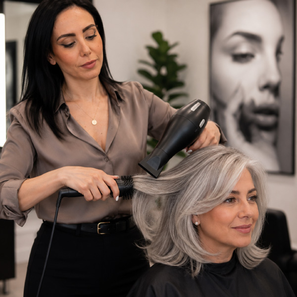 Master-stylist-at-Avissa-Salon-performing-a-beautiful-blowout-on-mature-female-client-in-Ann-Arbor-Michigan